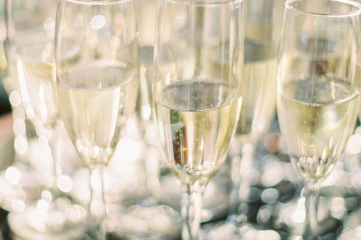 Champagne glasses on a black tray