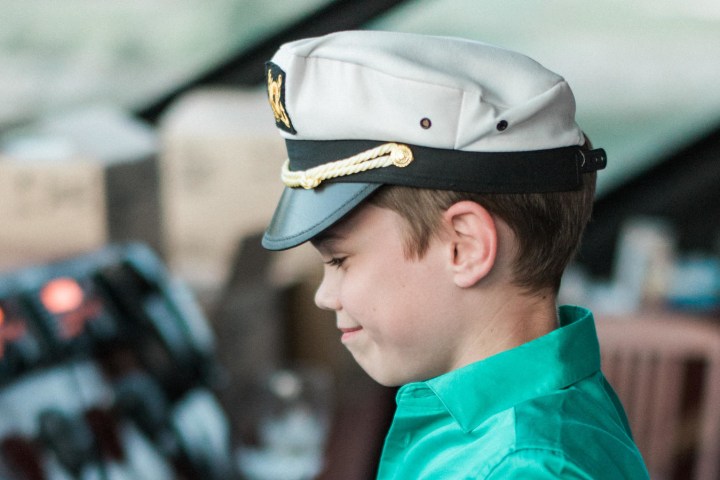 a close up of a boy wearing a hat